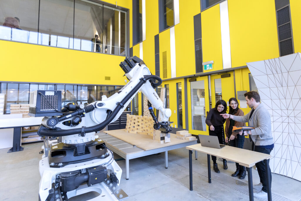 Robotic arm programmed by students to build intricate wall of building blocks